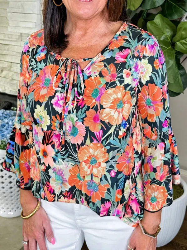 Floral 3/4 Flare Sleeve Tied Neck Blouse sold by Charming Charlie