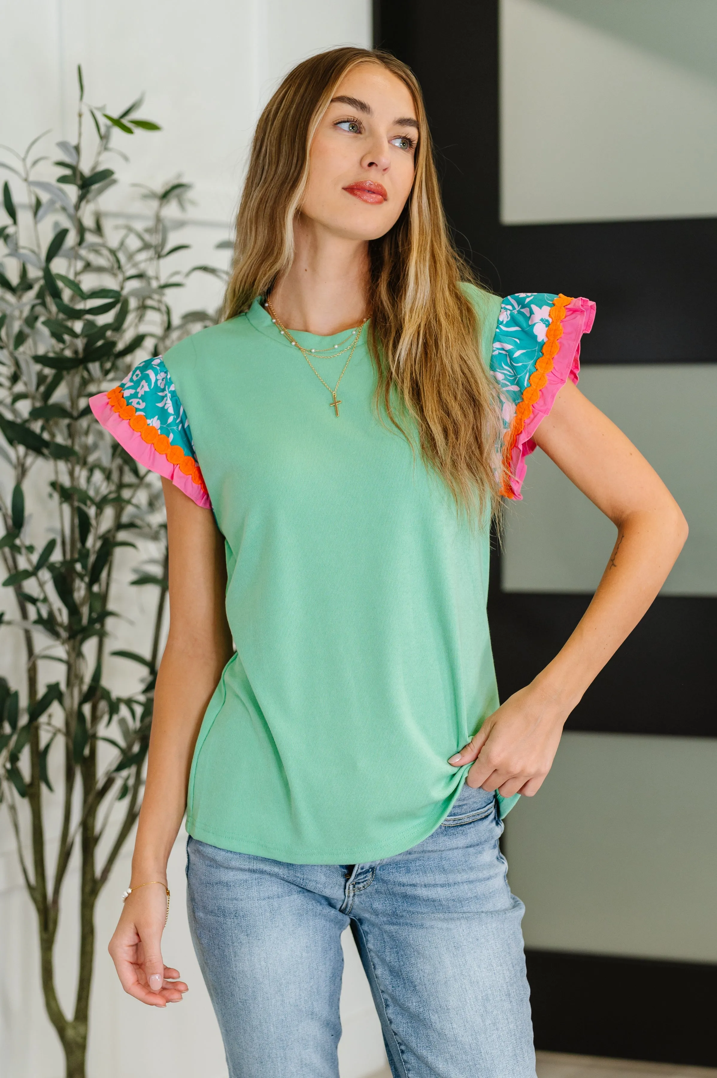 Petals & Poise Floral Flutter Sleeve Top in Green sold by Charming Charlie