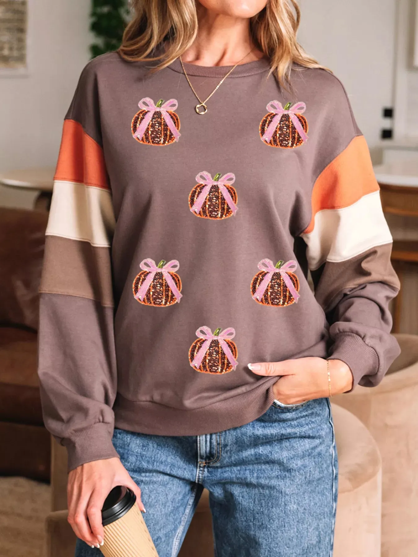 Sequin Bow Pumpkin Round Neck Sweatshirt sold by Charming Charlie