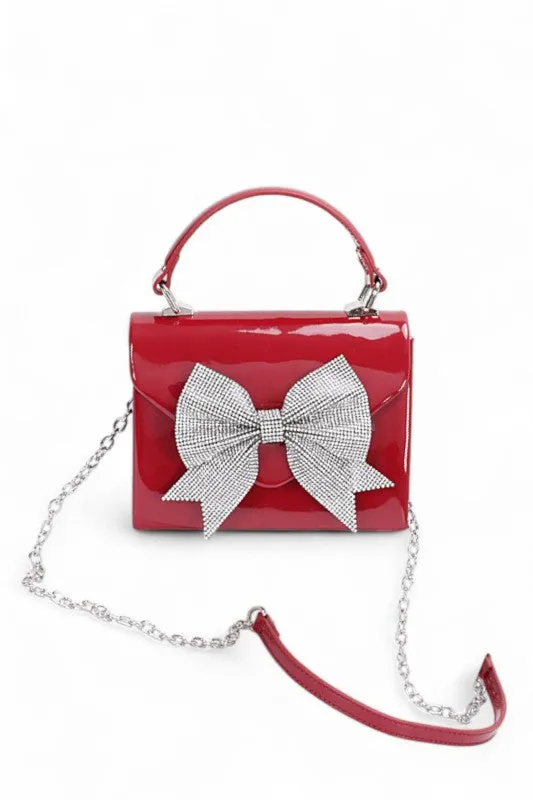 Rhinestone Bow Tie Patent Finish Crossbody Bag sold by Charming Charlie