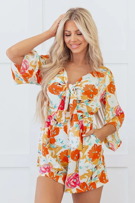 Orange Blooming Floral Print Front Tie Romper sold by Charming Charlie