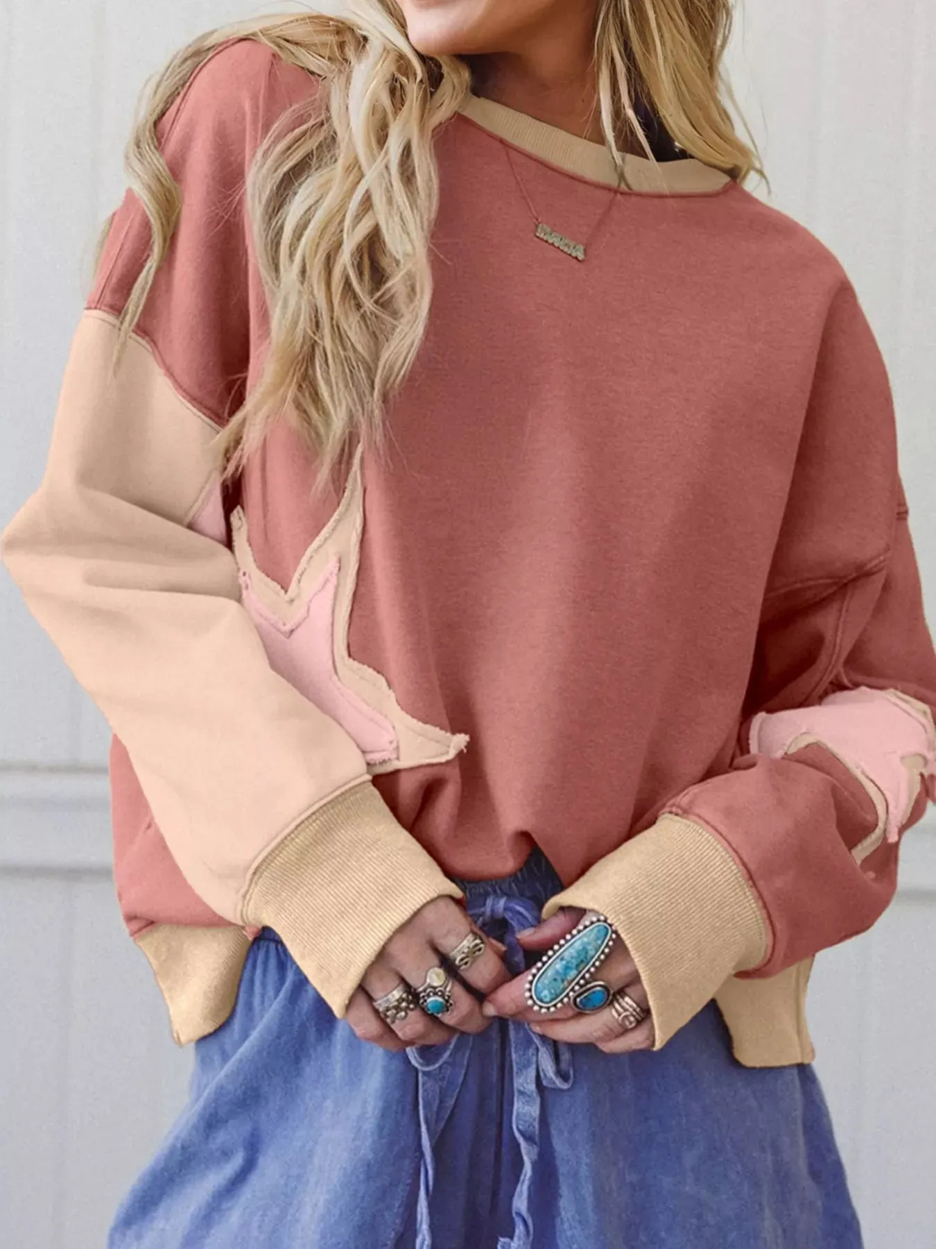 Contrast Star Patchwork Exposed Seam Uneven Hem Drop Shoulder Sweatshirt sold by Charming Charlie