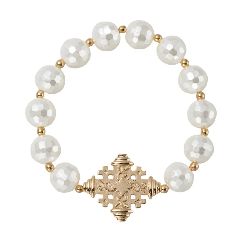 White Faceted Beaded Stretch Bracelet with Gold Decorative Cross sold by Charming Charlie