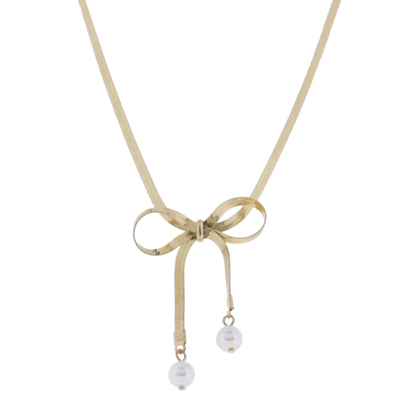 Gold Snake Chain Necklace with Gold Bow with Pearl Ends sold by Charming Charlie