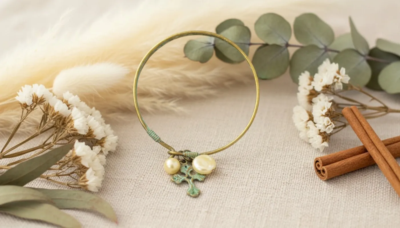 Brass Bangle with Pearls and Patina Cross Charm sold by Charming Charlie