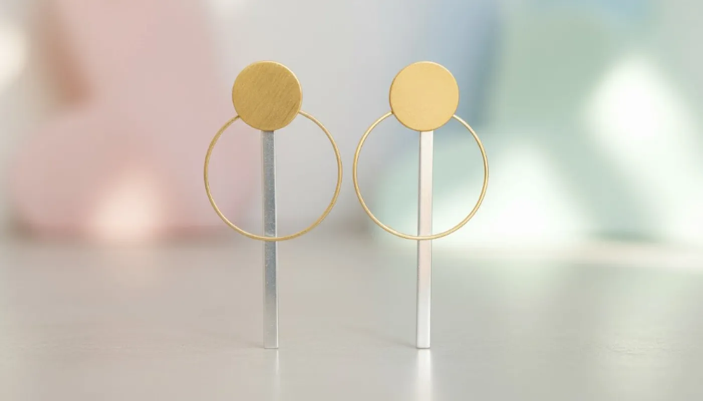 Dual-Tone Circle Drop Earrings sold by Charming Charlie