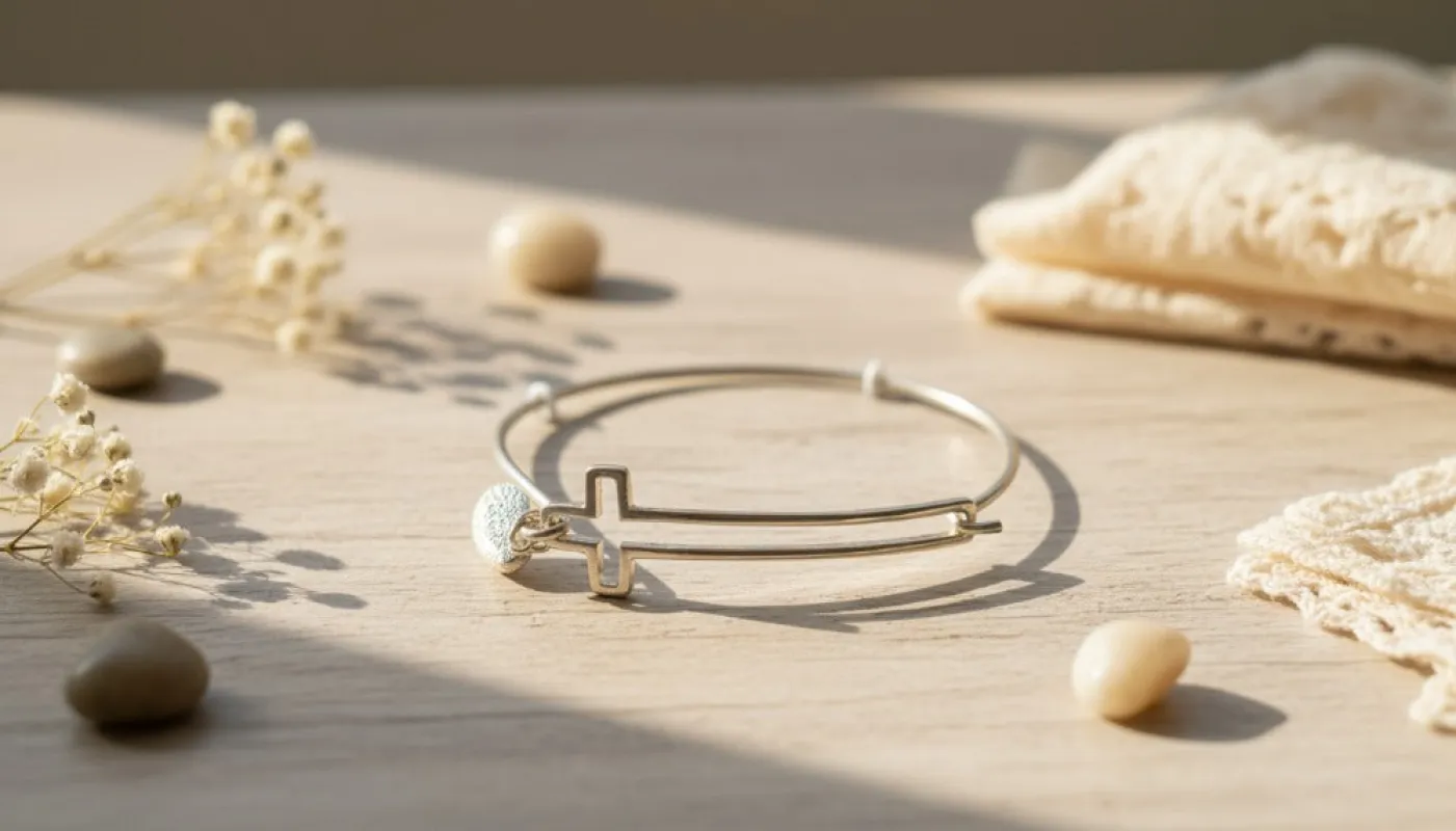 Gold Bangle with Cross Charm sold by Charming Charlie