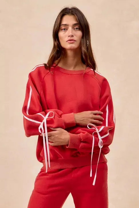 BiBi Side Lined Bow Details Fleece Sweatshirt sold by Charming Charlie