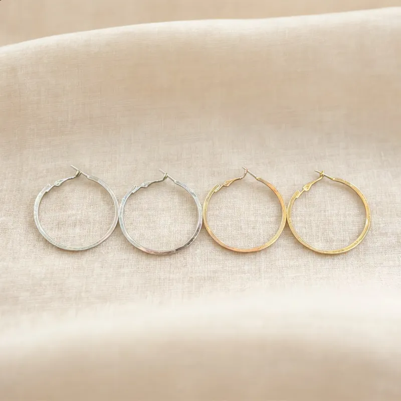 Silver and Gold Twisted Hoop Earrings sold by Charming Charlie