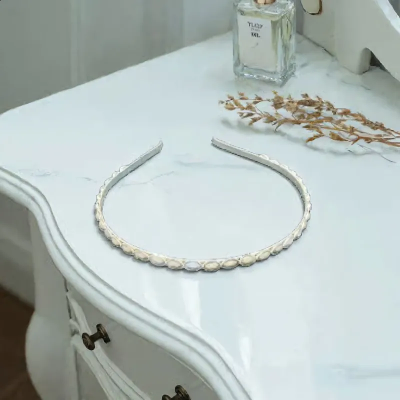 Pearl-Accented Headband sold by Charming Charlie