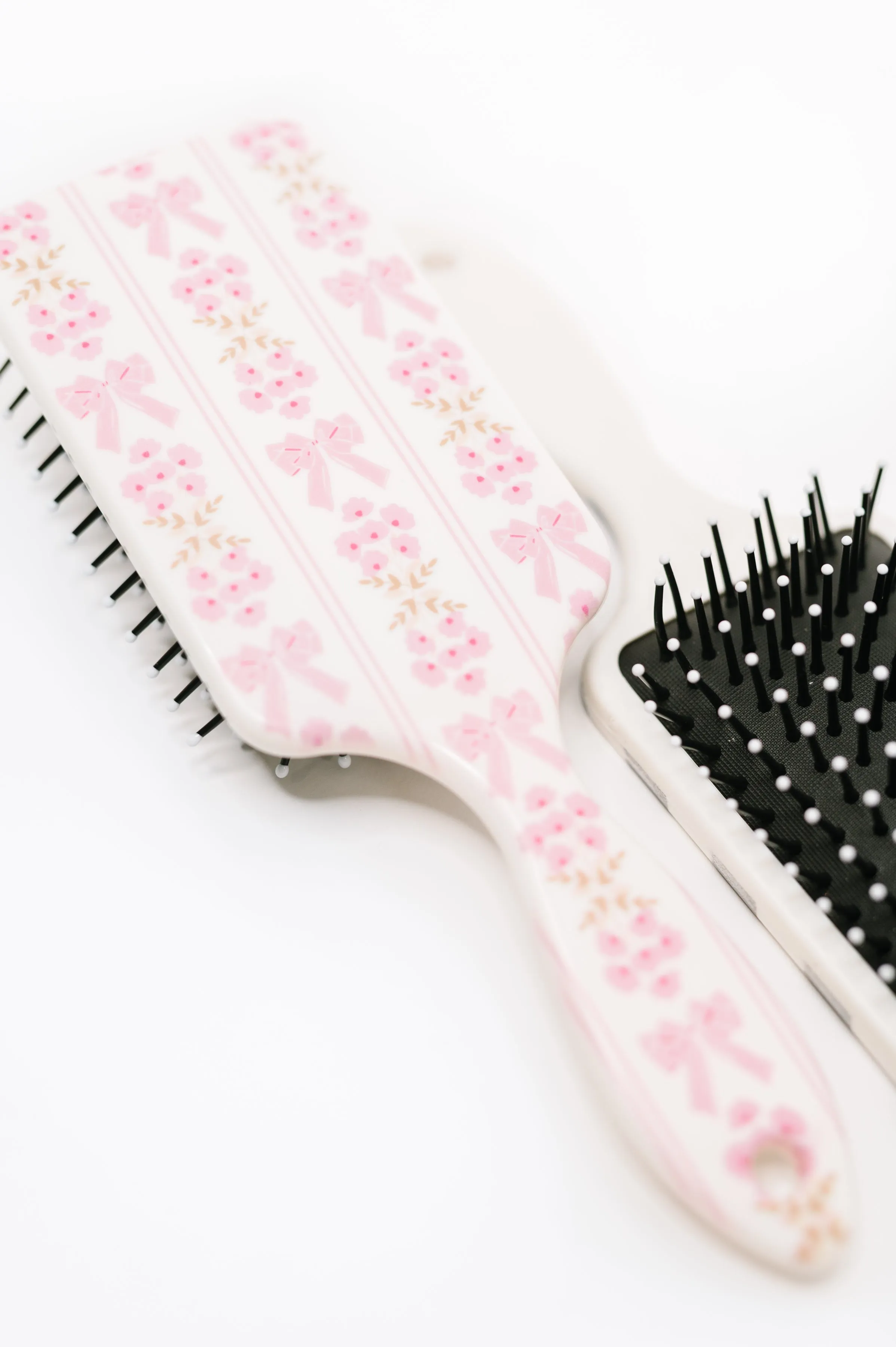 Girly Girl Bow and Floral Hair Brush sold by Charming Charlie