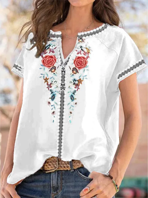 Full Size Floral Notched Short Sleeve Blouse Plus Size made by Trendsi