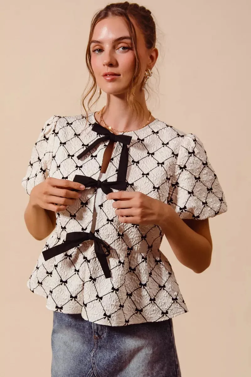 SO ME Bow Texture Woven Peplum Top With Contrast Tie sold by Charming Charlie