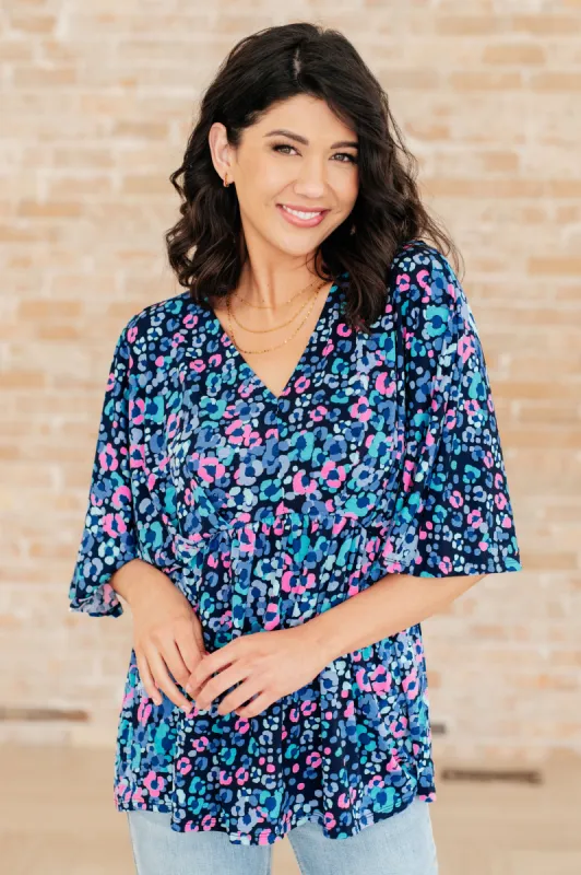 Dreamer Peplum Top in Navy and Lavender Animal Print sold by Charming Charlie
