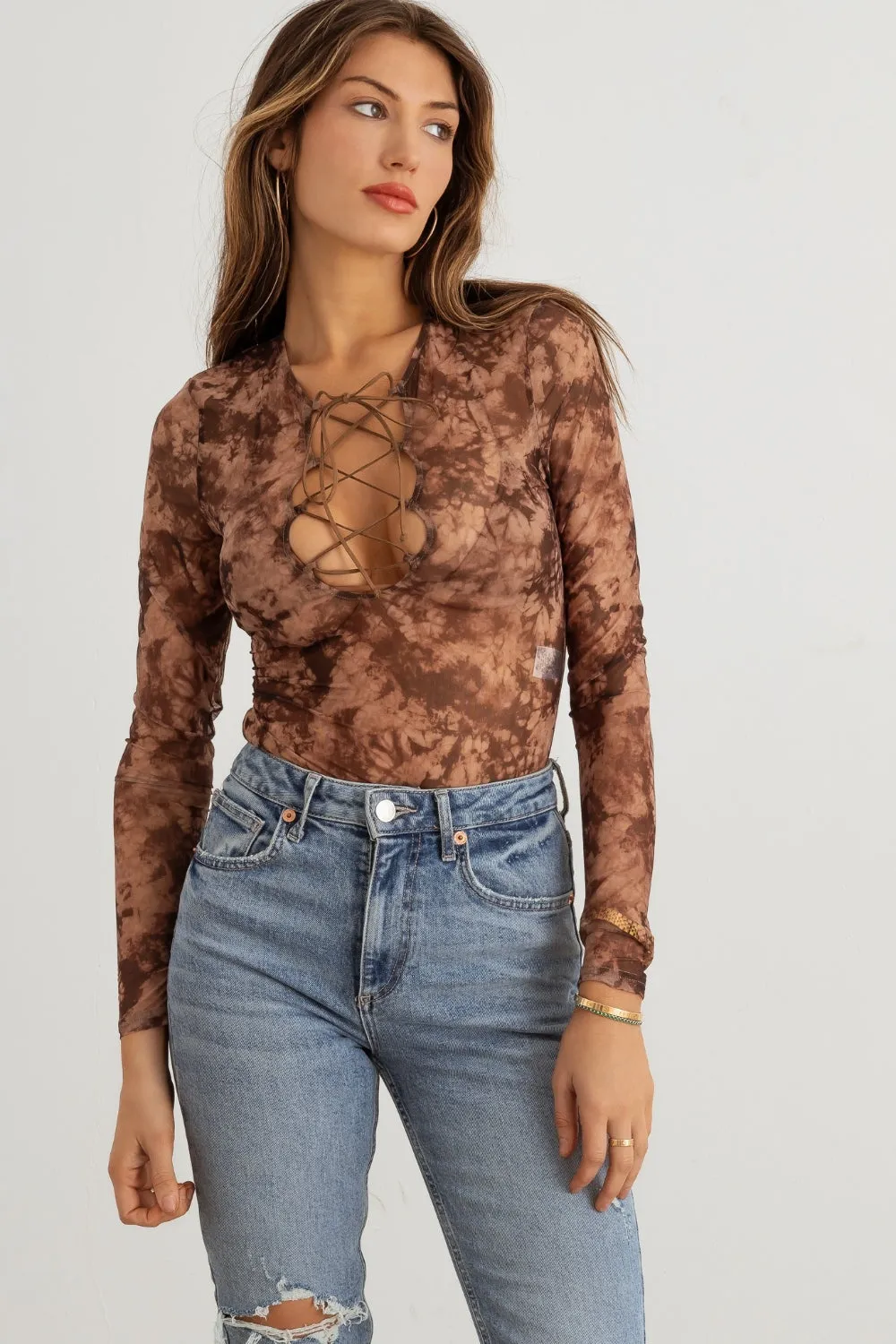 HERA COLLECTION Abstract Mesh Lace-Up Long Sleeve Bodysuit sold by Charming Charlie
