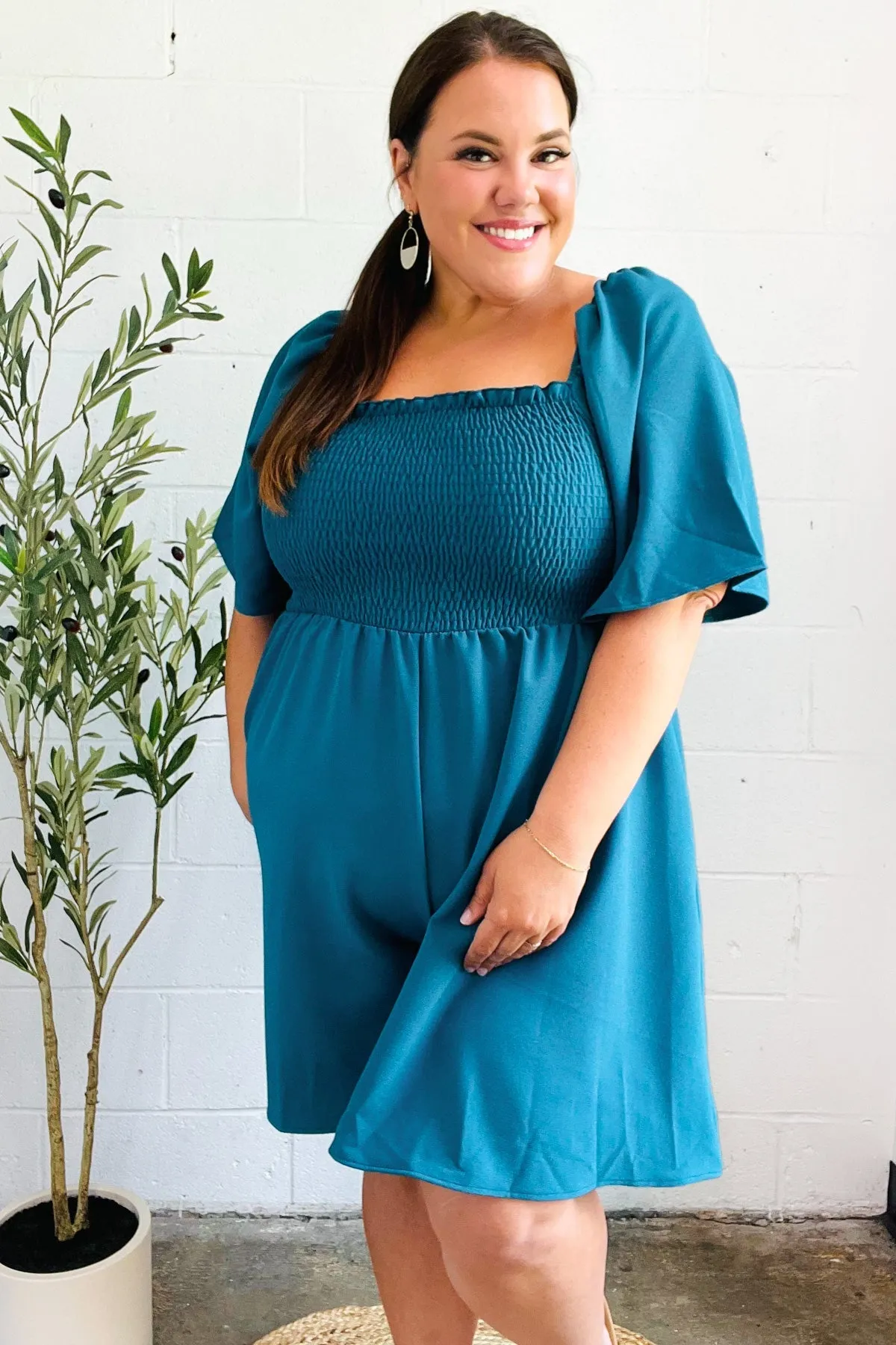 Feeling Playful Teal Smocked Flutter Sleeve Romper sold by Charming Charlie product image thumbnail 2