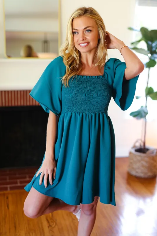 Feeling Playful Teal Smocked Flutter Sleeve Romper made by Charming Charlie