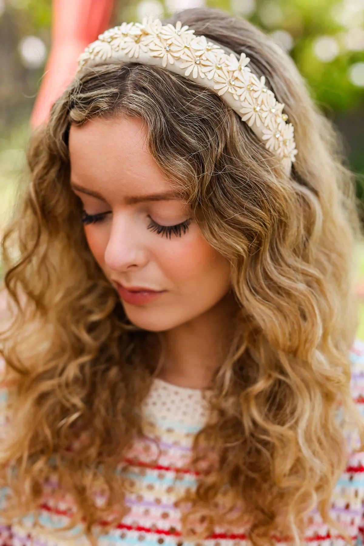 Oatmeal Satin Daisy Rhinestone Headband sold by Charming Charlie