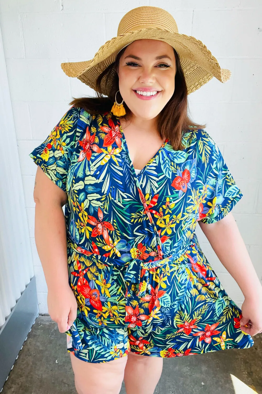 Navy Tropical Floral Surplice Romper sold by Charming Charlie