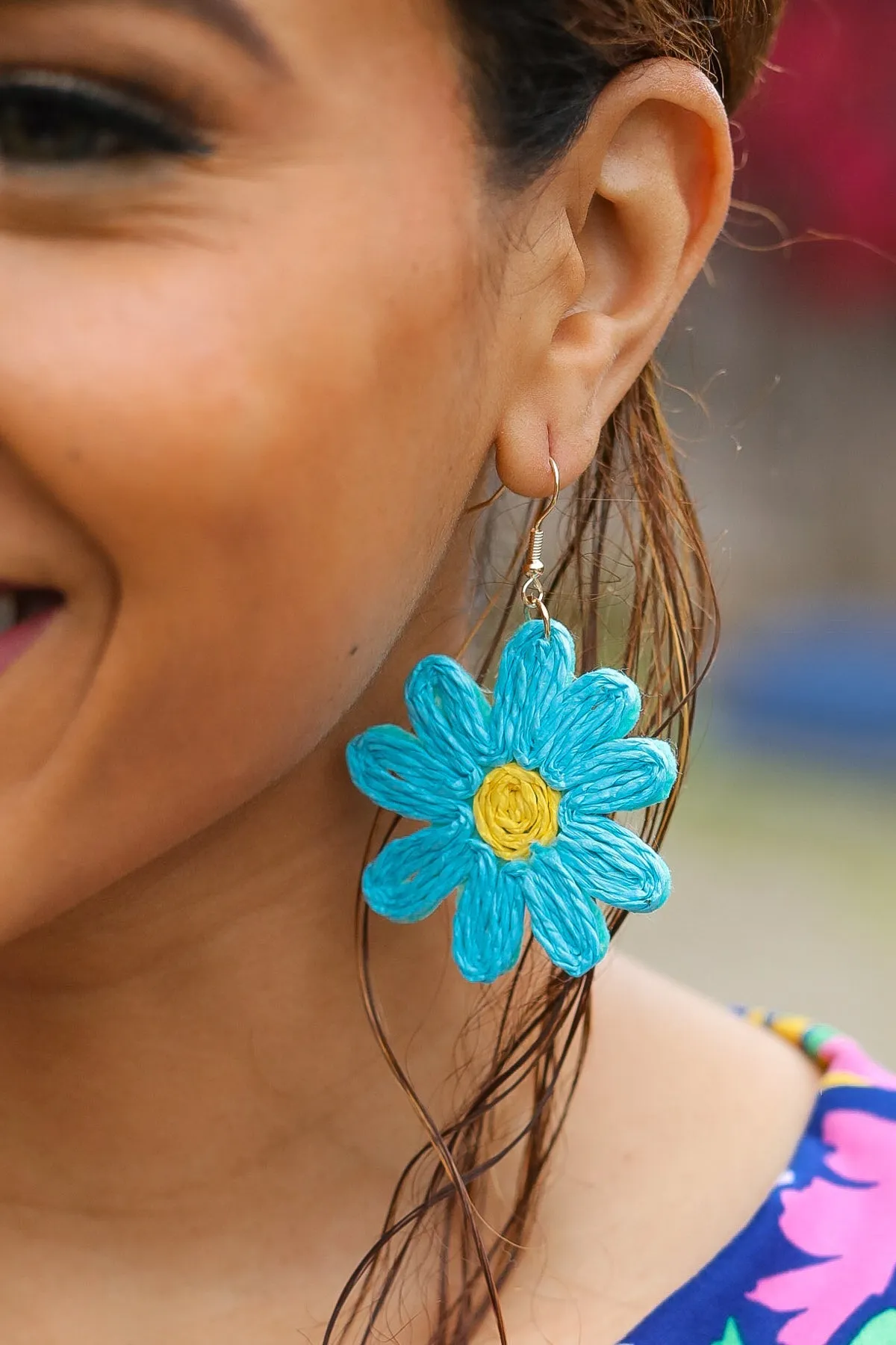 Sky Blue Daisy Flower Straw Dangle Earrings sold by Charming Charlie