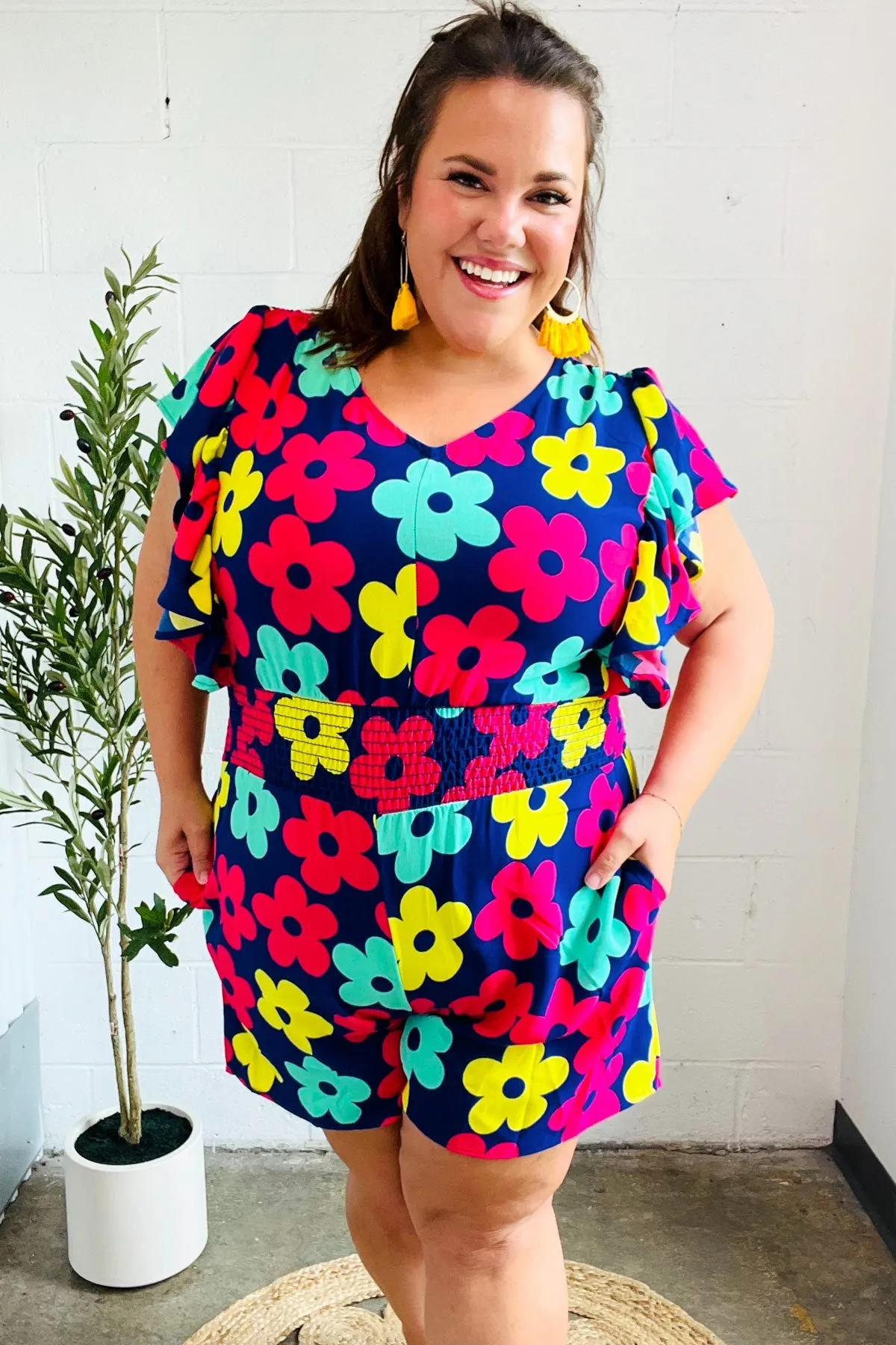 Feeling Bold Navy & Fuchsia Flat Floral Smocked Waist Flutter Sleeve Romper sold by Charming Charlie