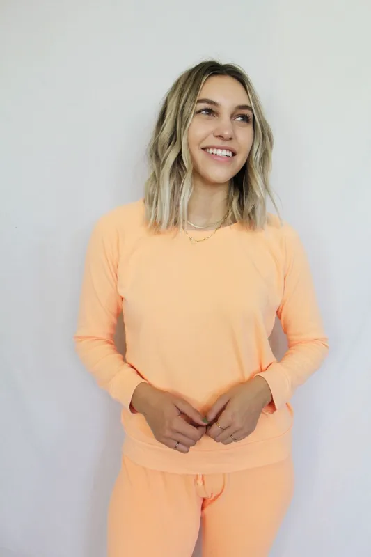 Cotton Fleece Long Sleeve Raglan Pullover in Neon Orange sold by Chaser