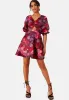 Puff Sleeve Twist Bodice Floral Mini Dress in Purple sold by Chi Chi London