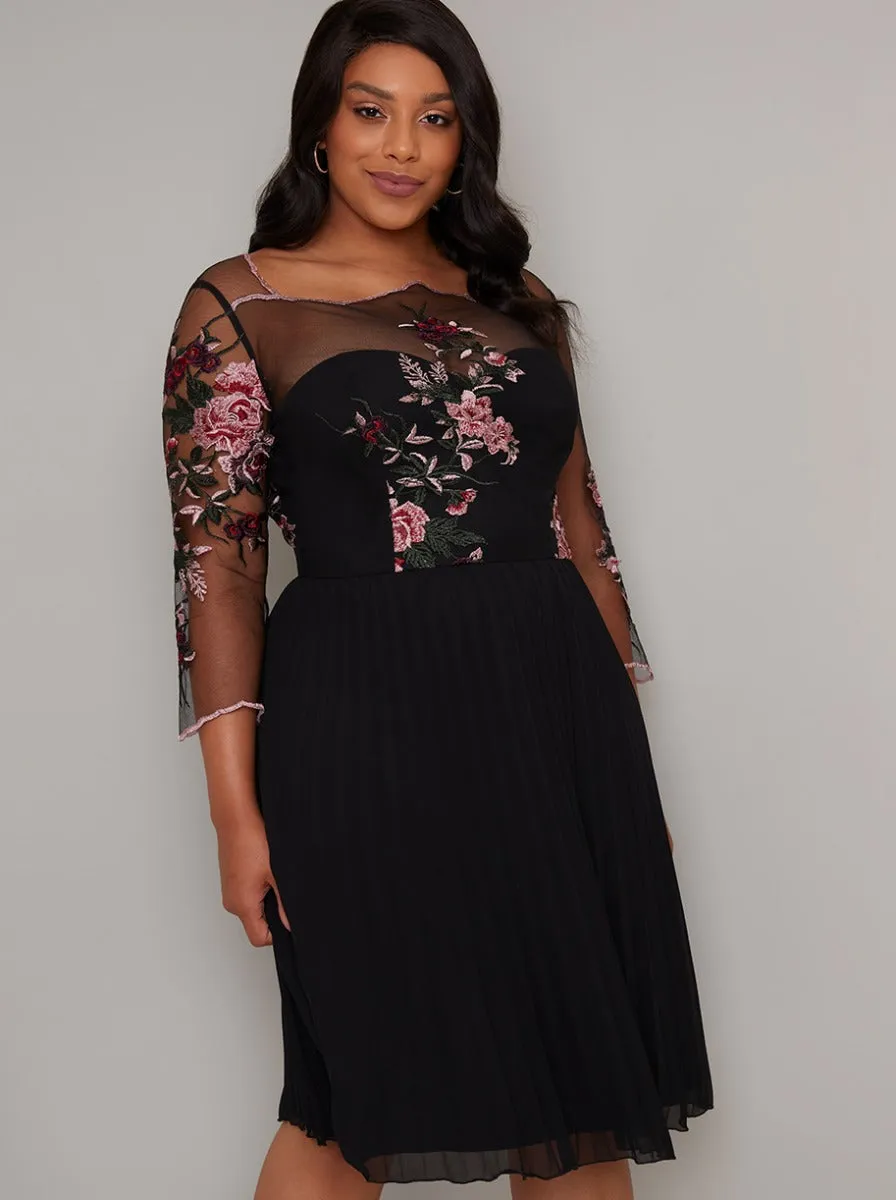 Plus Size Sheer Sleeved Pleat Midi Dress in Black sold by Chi Chi London