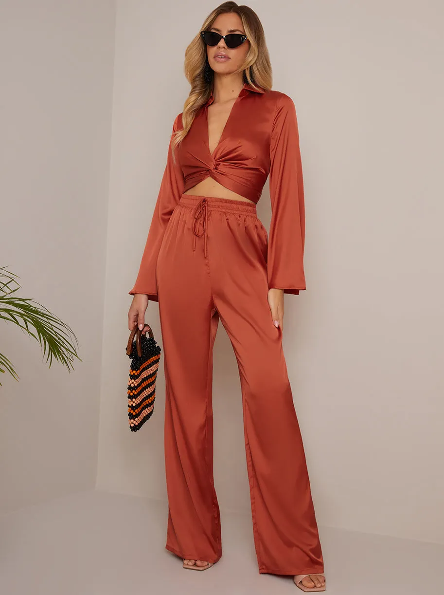 Long Sleeve V Neck Satin Twist Detail Top in Burnt Orange sold by Chi Chi London