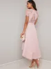 Lace Bodice Detail Dip Hem Dress in Pink sold by Chi Chi London