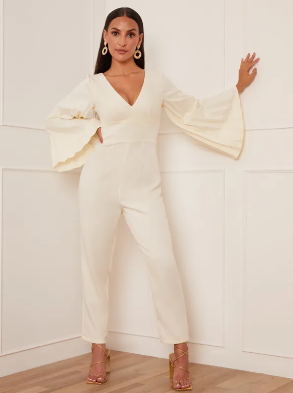 Petite Long Bell Sleeve Pleated Jumpsuit in Cream sold by Chi Chi London