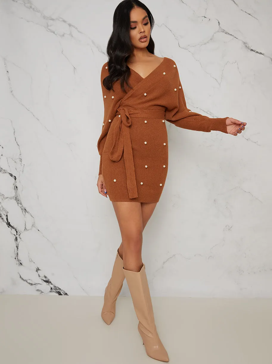 Pearl Design Wrap Detail Jumper Dress In Tan sold by Chi Chi London