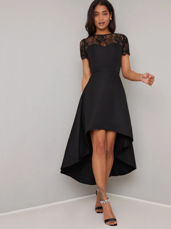 Short Sleeved Sheer Lace Dip Hem Midi Dress in Black sold by Chi Chi London