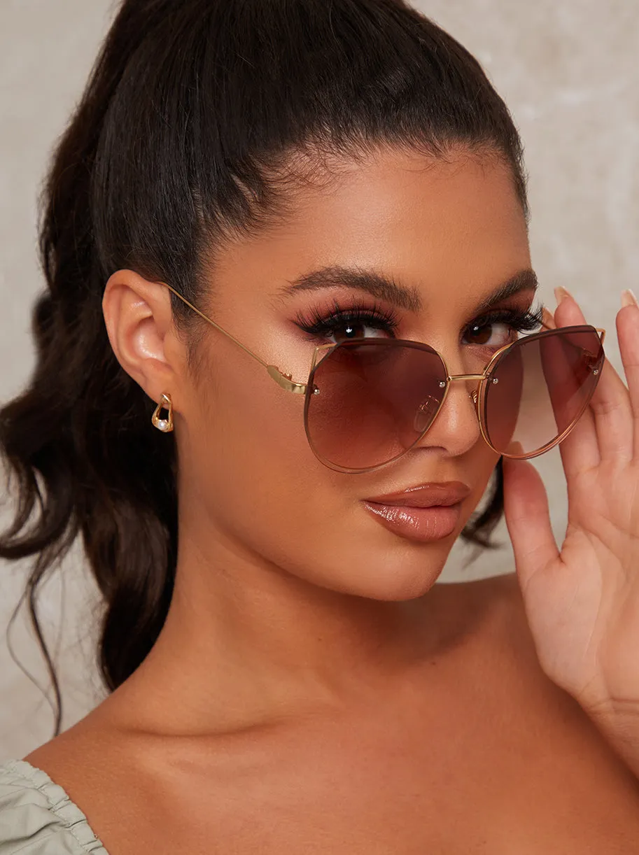 Oversized Rounded Cat Eye Sunglasses in Brown sold by Chi Chi London