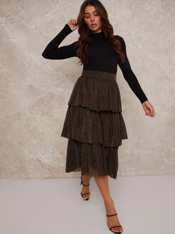 Ruffle Tiered Dip Hem Maxi Skirt in Gold sold by Chi Chi London