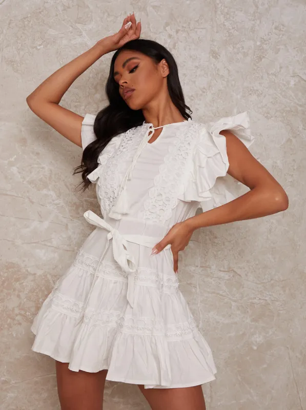 Ruffle Sleeve Broderie Mini Dress in White sold by Chi Chi London