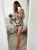 Floral Print Long Sleeved Playsuit in Cream sold by Chi Chi London