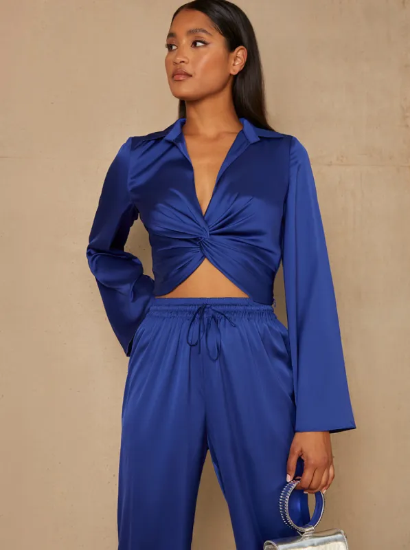 Long Sleeve V Neck Satin Twist Detail Top in Blue sold by Chi Chi London