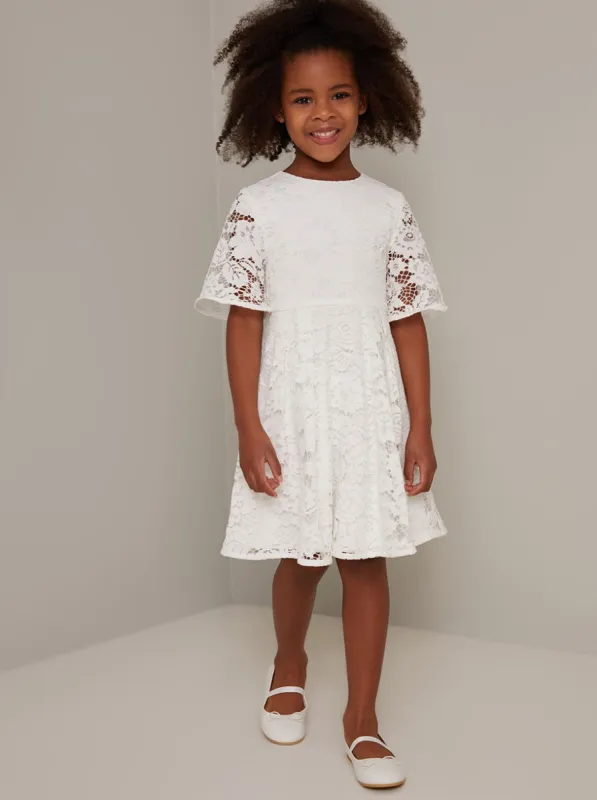 Girls Short Sleeved Lace Overlay Dress in White sold by Chi Chi London