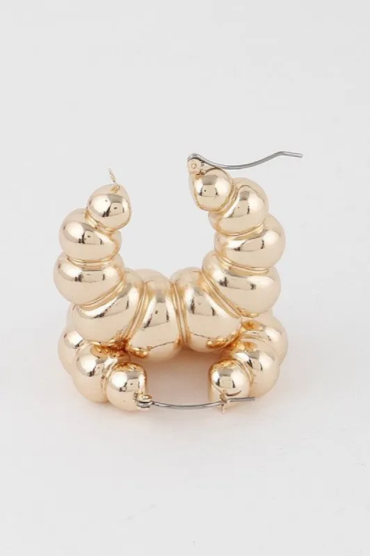 Chandra Gold Bulky Croissant Hoop Earrings sold by Chic Couture