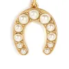 Pearl Horseshoe Charm sold by Clare Vivier