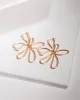 Gold Lined Flower Statement Earrings sold by Collete Hayman