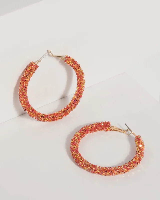 Orange Glitter Encrusted Hoop Earrings sold by Collete Hayman