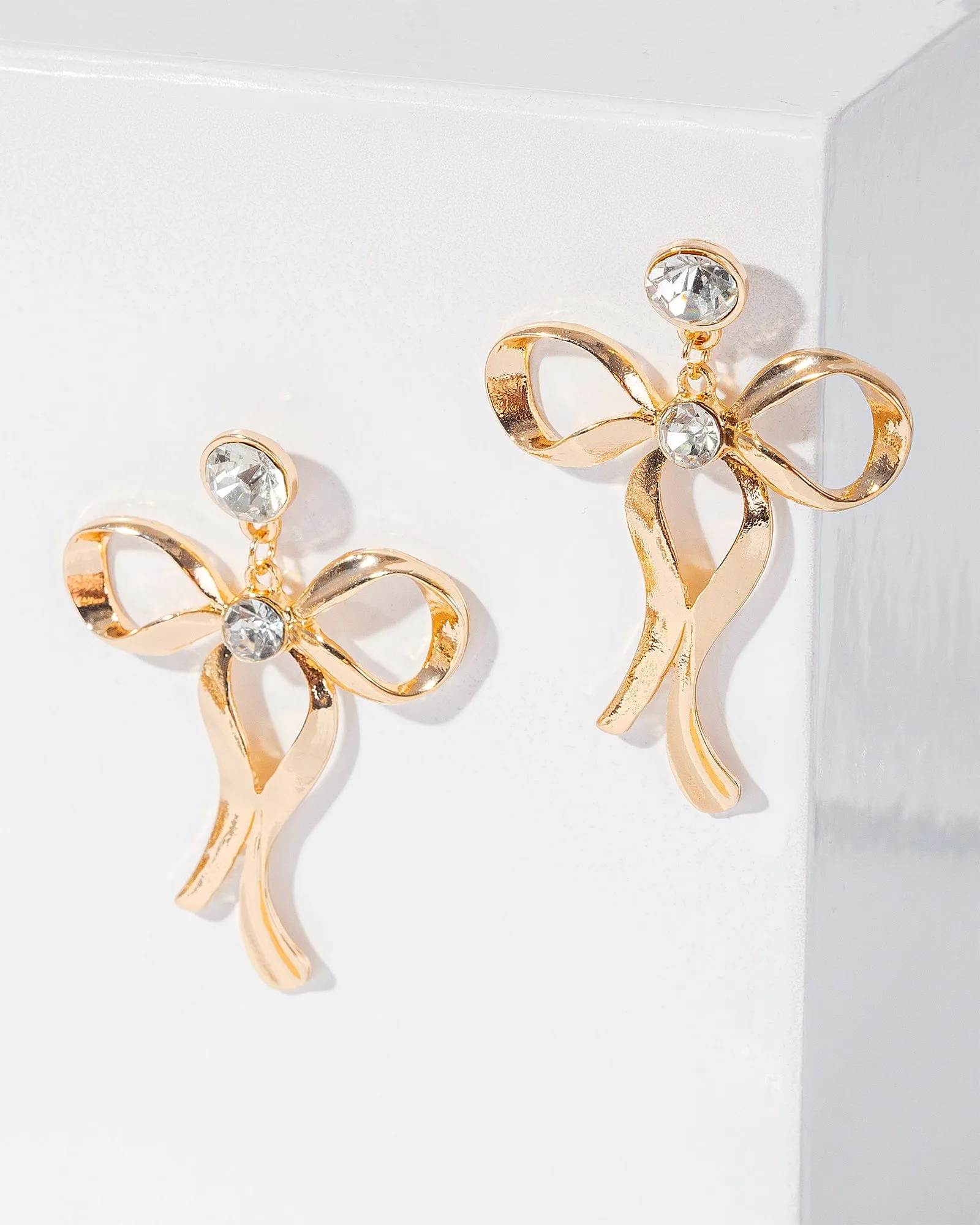 Gold Metal Bow Drop Earrings sold by Collete Hayman