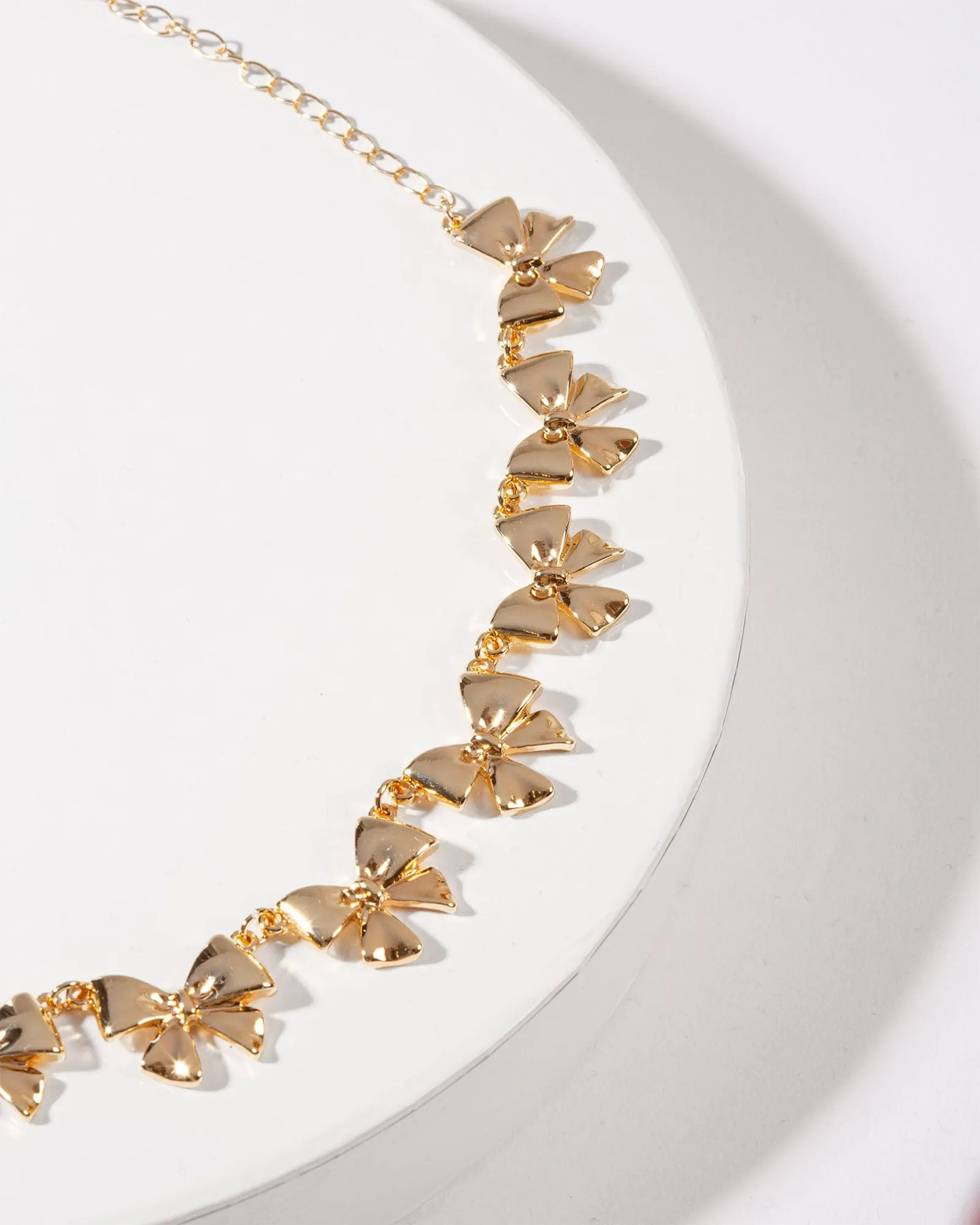 Gold Metal Bow Necklace sold by Collete Hayman