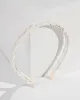 White Fabric And Pearl Twisted Headband sold by Collete Hayman