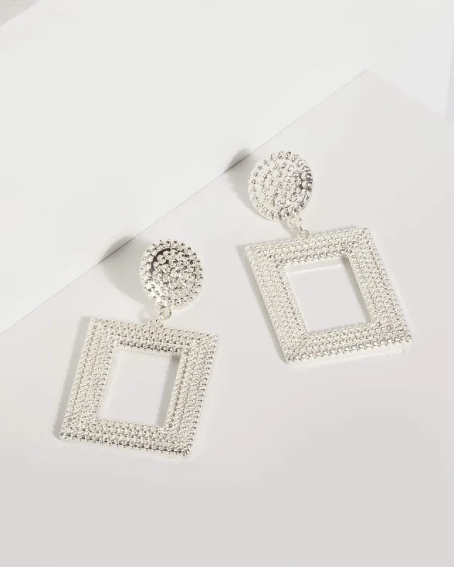 Silver Metal Textured Drop Earrings sold by Collete Hayman