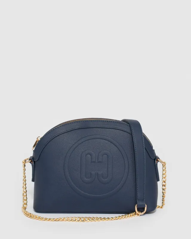 Navy Blue Raina Embossed Crossbody Bag sold by Collete Hayman
