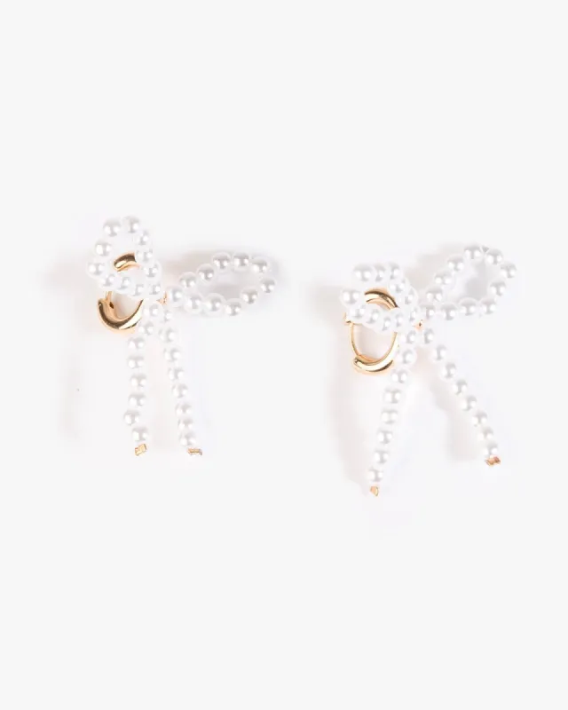 White Beaded Bow Huggie Hoop Earrings sold by Collete Hayman