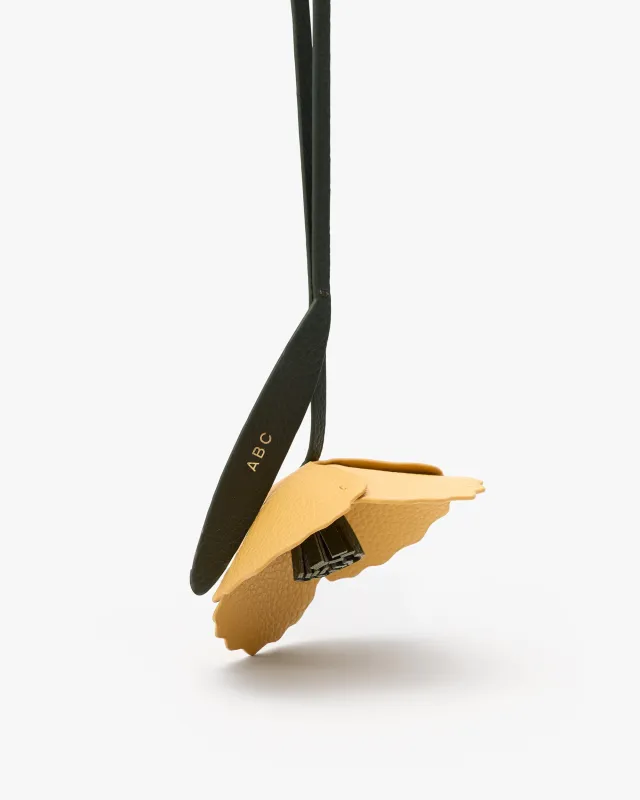 Poppy Charm sold by Cuyana